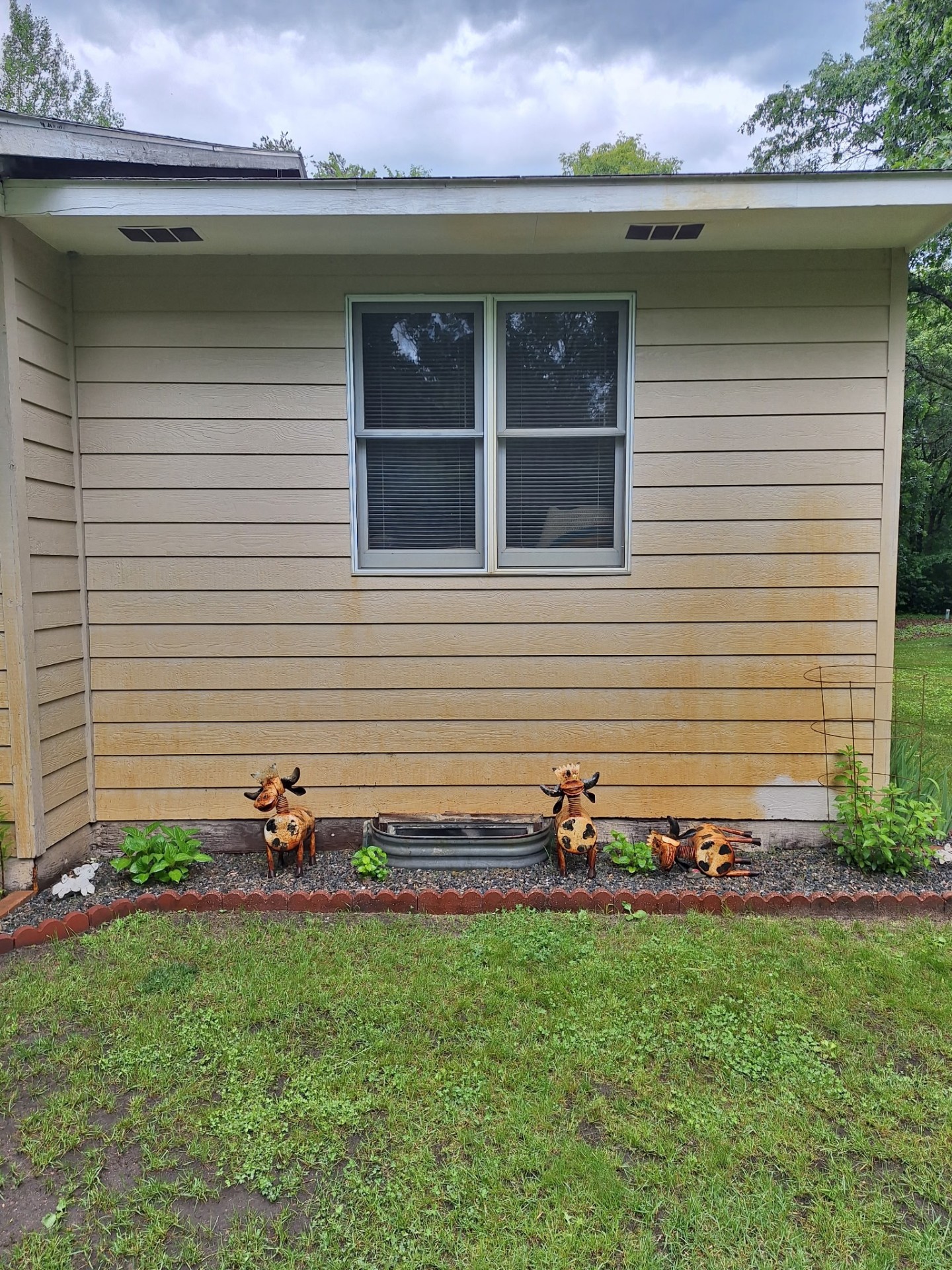 Siding with heavy rust and hard-water staining before treatment