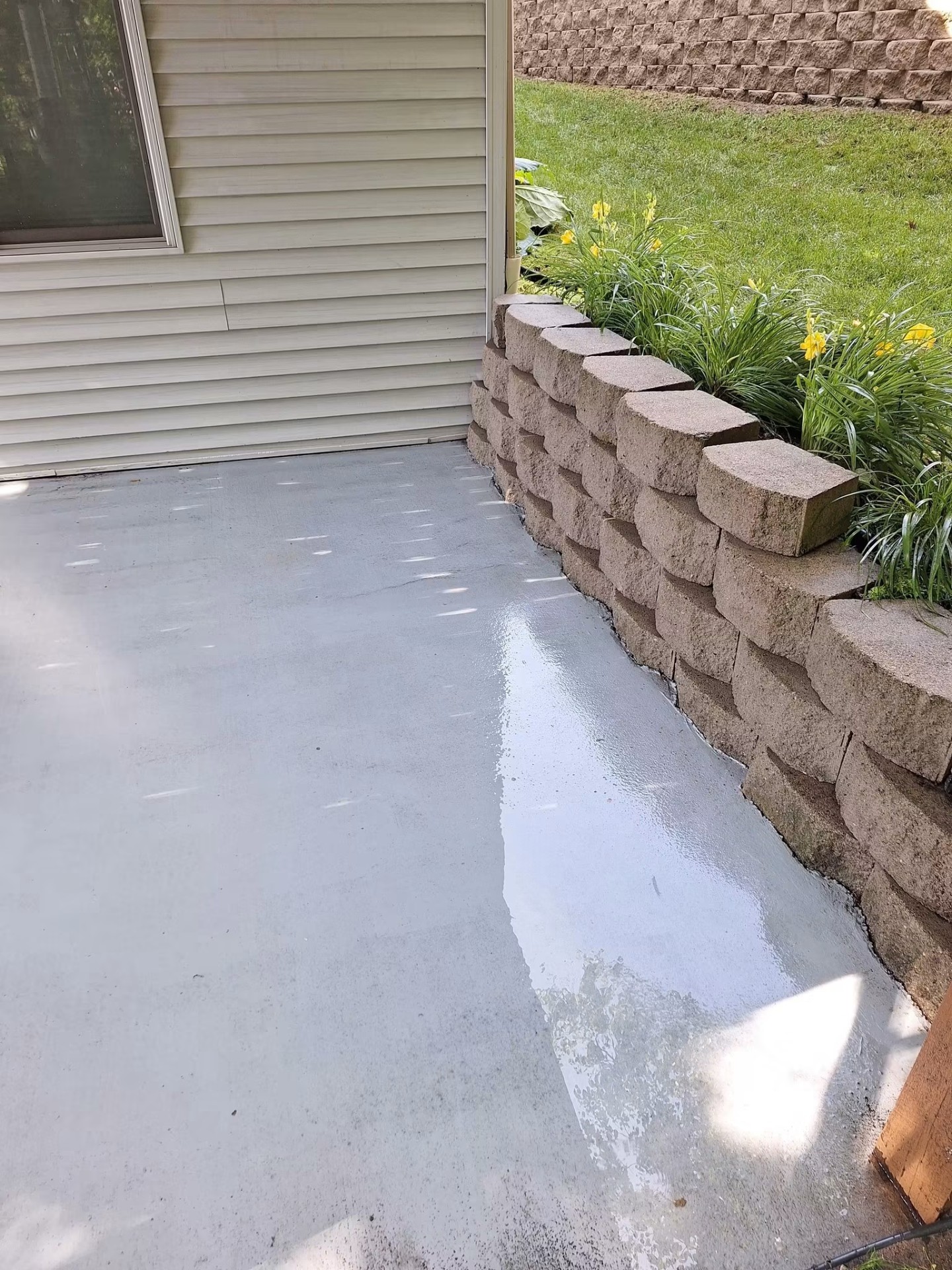 Concrete patio bright and clean after pressure washing